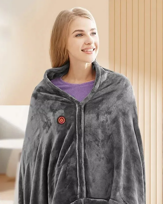 Blonde woman wearing a gray, heated, wearable blanket while standing