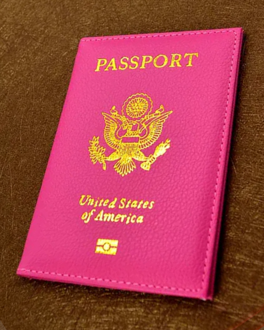 A hot pink passport cover with "PASSPORT", the seal of the USA, and "United States of America" in gold