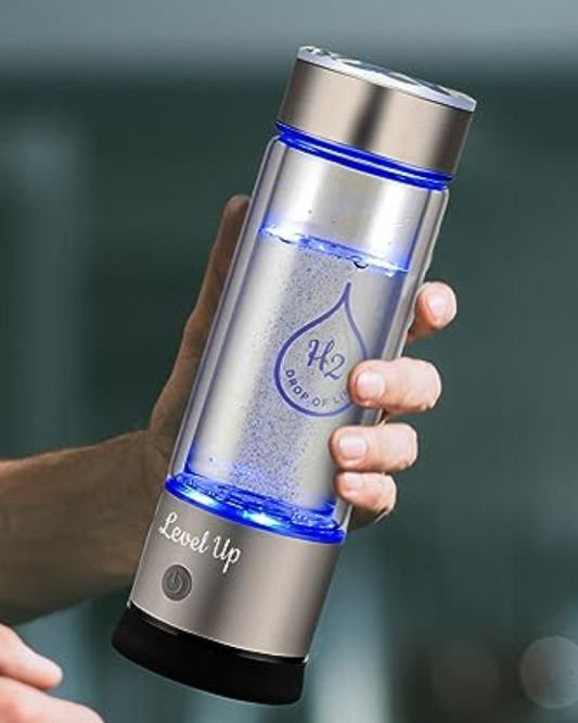 Person holding a silver hydrogen ionized water bottle