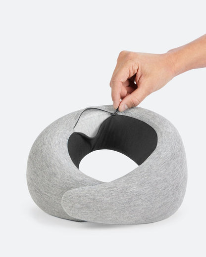 Gray memory foam neck pillow with the zip open showing the soft interior